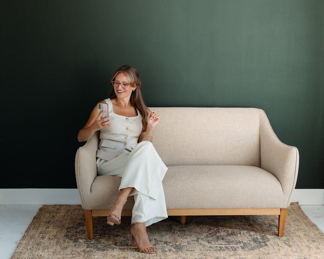 Alex on a sofa, checking her phone